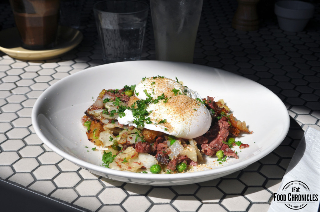 Corned beef hash with garden peas, poached egg and parmesan crumbs