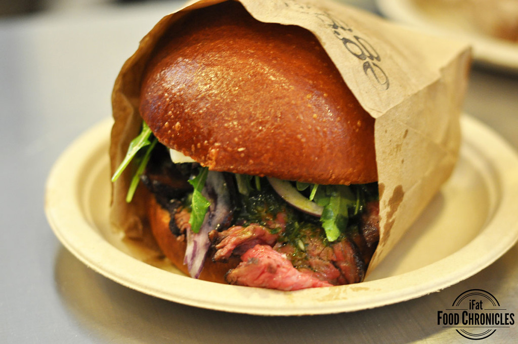 Gaucho with seared wagyu tri-tip steak, chimichurri, pickled red onions and seasoned arugula topped with an over medium egg, in a warm brioche bun